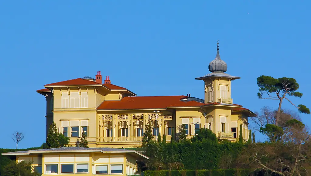 Vahdettin Köşkü; sarı cepheli iki katlı yapı, kırmızı kiremit çatı, soğan kubbeli kule ve mavi gökyüzü.