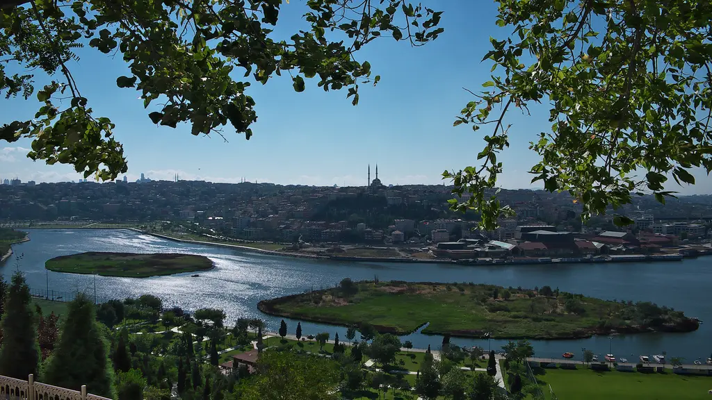 Pierre Loti Tepesi'nden Haliç'teki adacıklar; yaprakların arasından görünen su, yeşil adalar, karşı kıyı ve uzakta minareler.