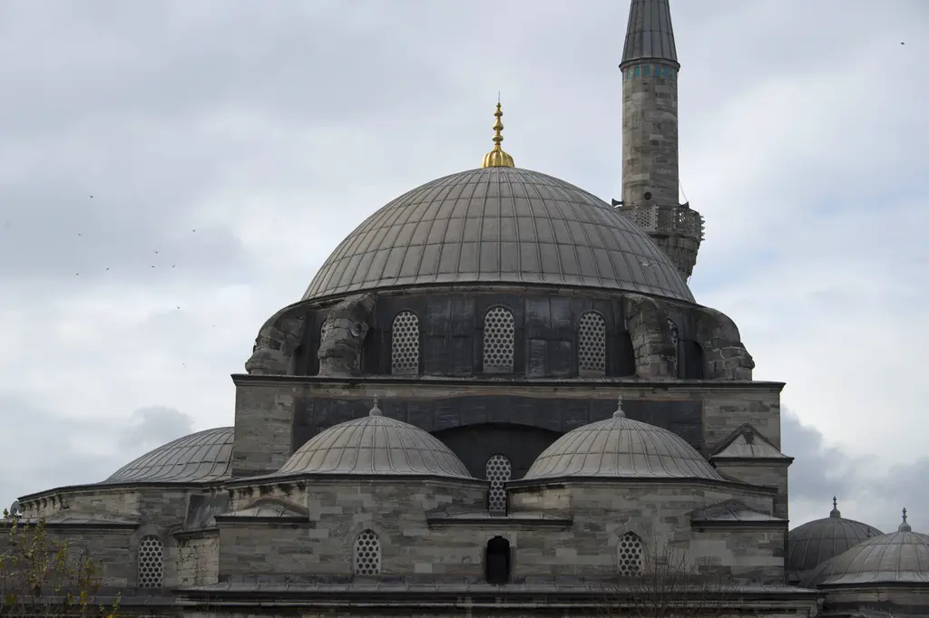 Vezir Han'dan Gazi Atik Ali Paşa Camii; kasnağında pencere dizisi bulunan kurşun kubbe, altta yarım kubbeler ve yanda minare.