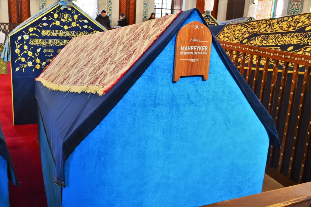 Kösem Sultan'ın sandukası; mavi kadife örtünün üstünde işlemeli kumaş, başında ahşap isim levhası ve yanında sedef kakmalı parmaklık.