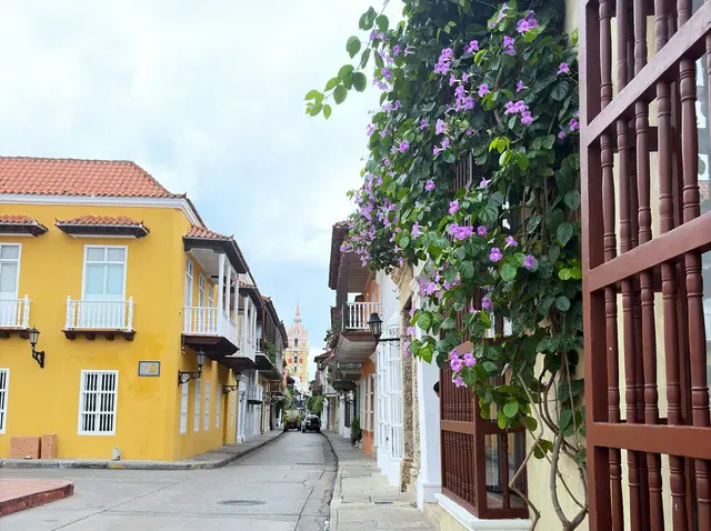 Cartagena'da tarihî merkez; sarı, mavi ve turuncu boyalı sömürge cepheleri, ahşap balkonlar ve çiçekli sokak.