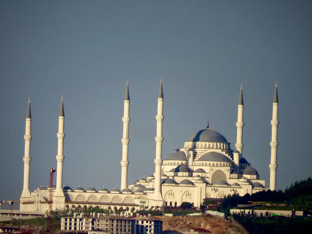 Büyük Çamlıca Camii; gri gökyüzü önünde ana kubbe, kademeli yarım kubbeler ve iki yanda yükselen altı minare.