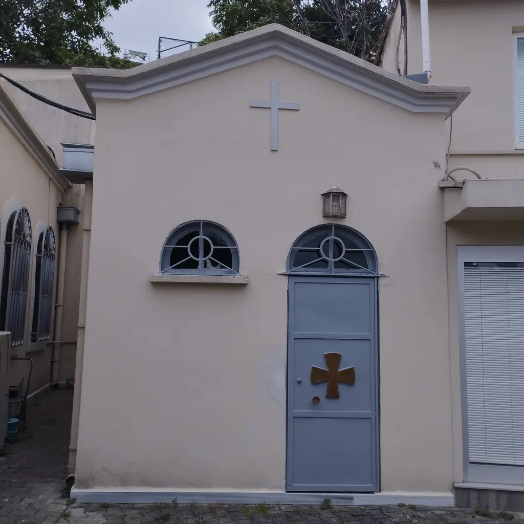 Avludaki küçük yapı; üçgen alınlıkta haç, yarım daire pencereli kemerli ön cephe ve üzerinde haç işli mavi gri kapı.