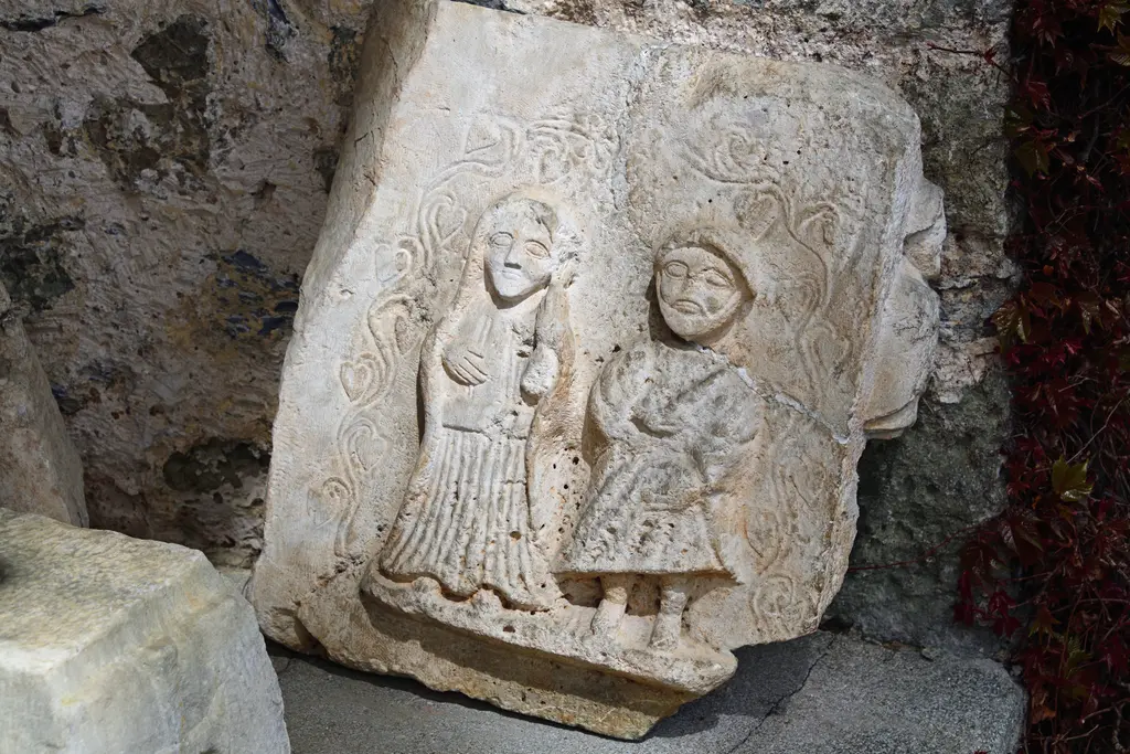 Sadberk Hanım Müzesi'nde kabartmalı taş eser; yan yana duran iki giyimli figür ve kırık kenarlı beyaz mermer levha.